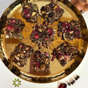 Homemade Choco Nutty Bars with nuts and seeds on a wooden board—healthy, protein-rich kids’ snack made with pure cow ghee, no sugar or oil.