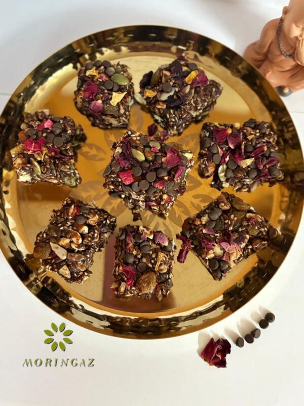 Homemade Choco Nutty Bars with nuts and seeds on a wooden board—healthy, protein-rich kids’ snack made with pure cow ghee, no sugar or oil.